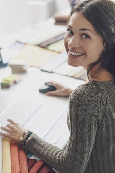 smiling-interior-designer-working-at-desk-1.jpg